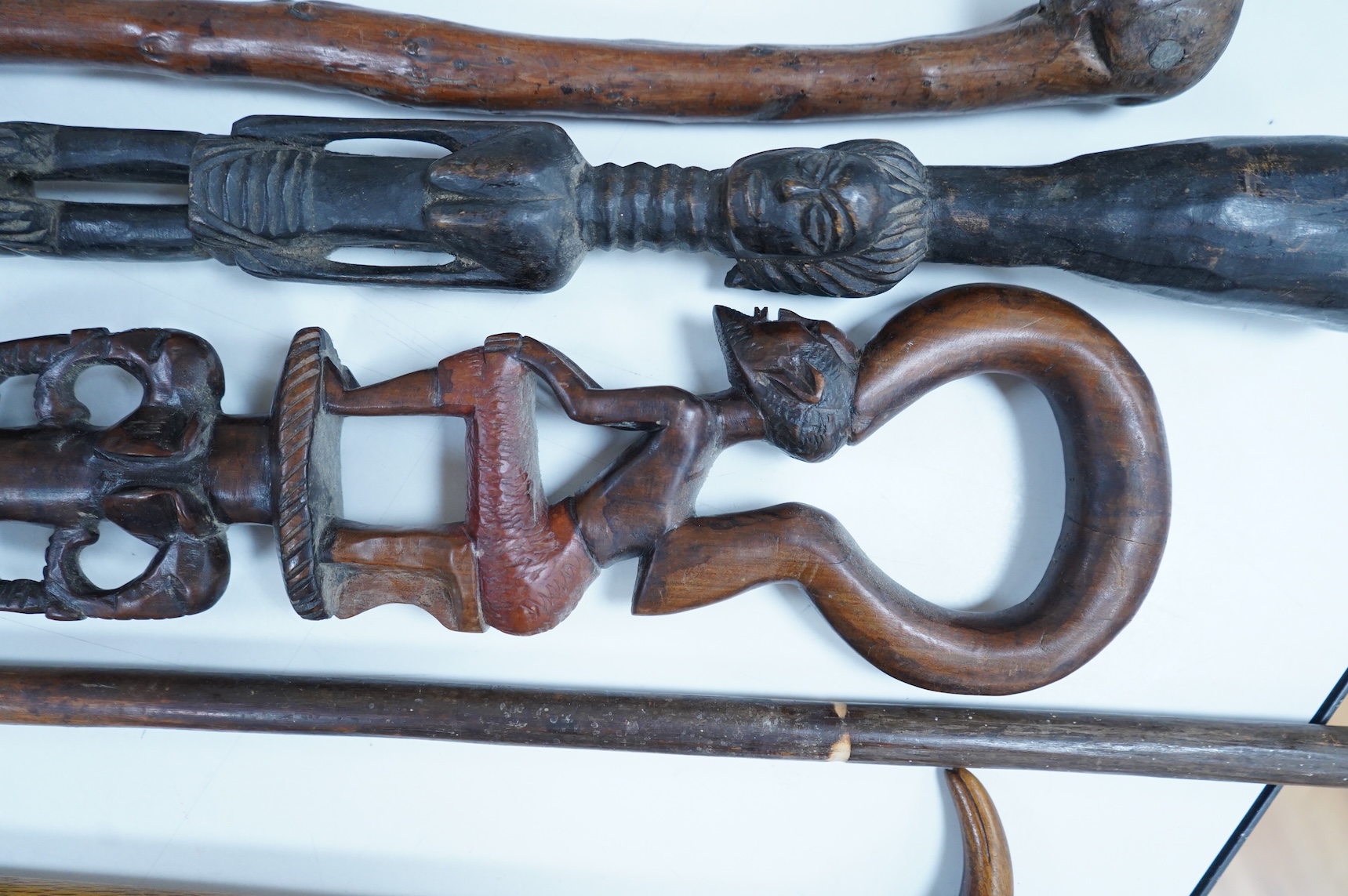 A collection of African and other walking sticks and walking canes - ebonised cane 105 cm long